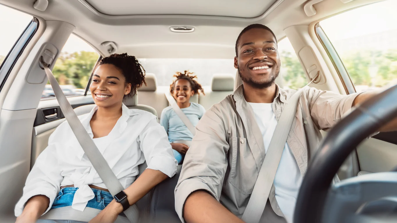 Happy African American Family Riding Car Traveling By Automobile. Black Parents And Daughter Enjoying Summer Road Trip Together On Weekend. Panorama, Selective Focus - auto insurance