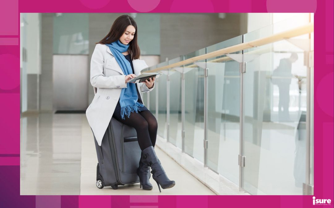 cyber safety travel tips - Airport business woman with smart phone at gate waiting in terminal. Air travel concept with young casual businesswoman. Beautiful young tourist girl with luggage in international airport