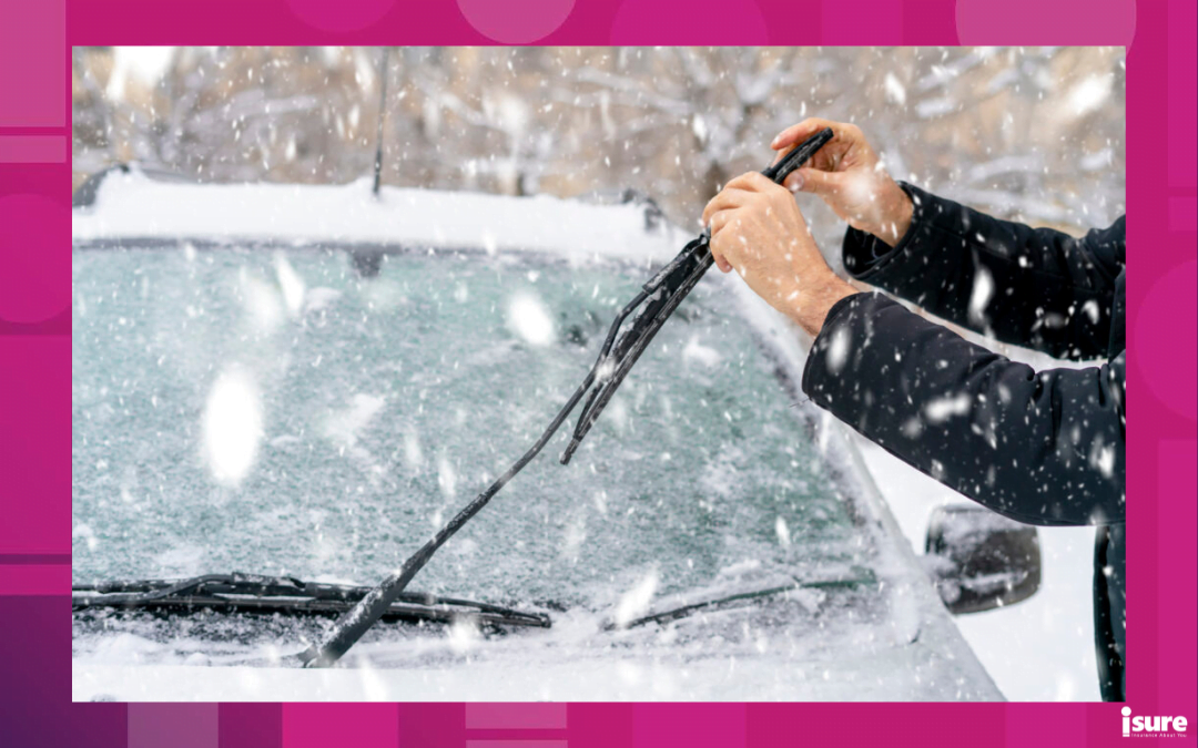 car winter ready - close up of hands changing wiper blades in snowy winter season