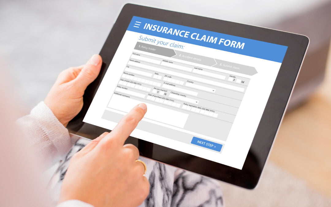 auto insurance fraud - image of a person filling out an auto insurance claim on an ipad