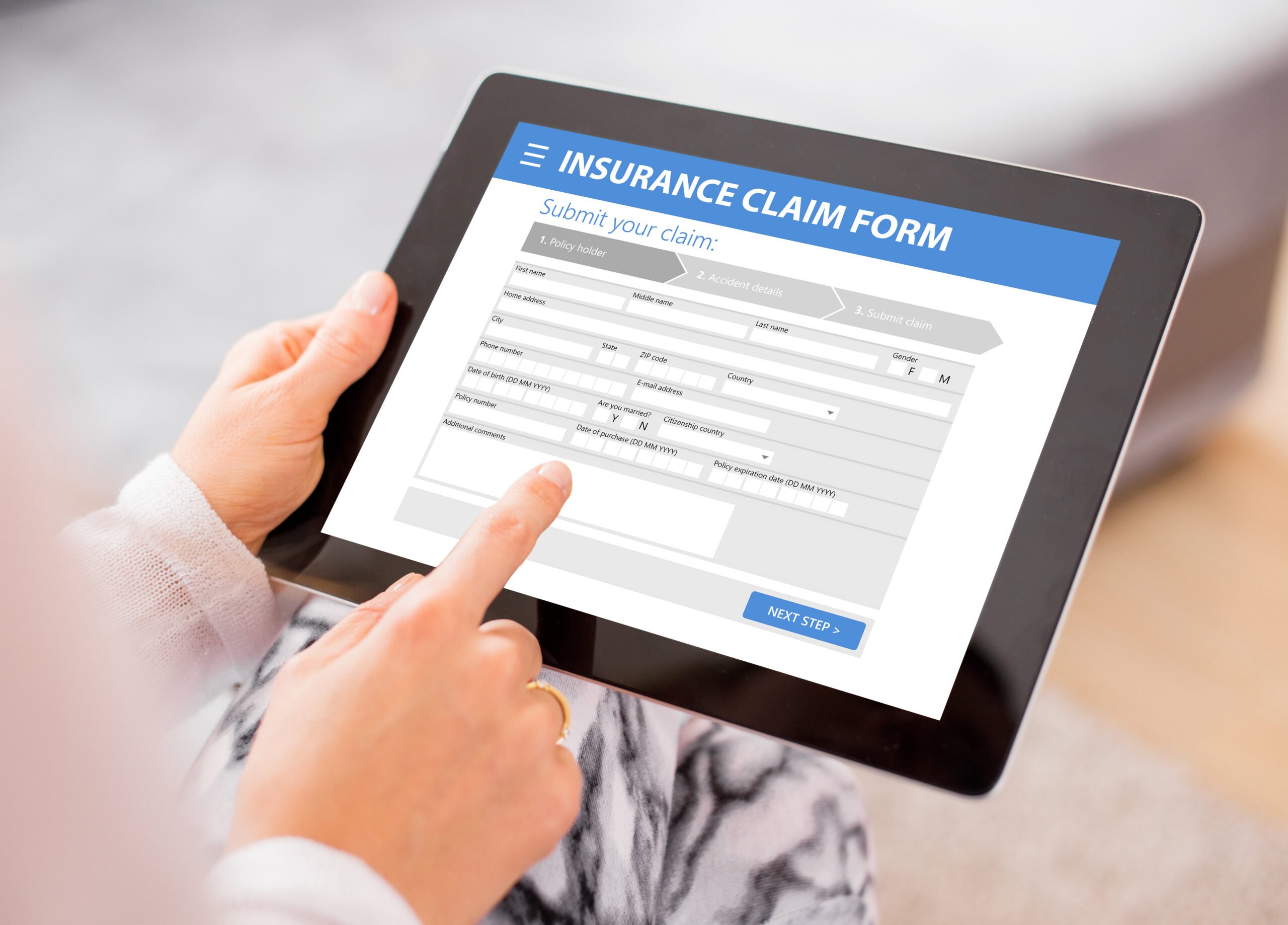 auto insurance fraud - image of a person filling out an auto insurance claim on an ipad