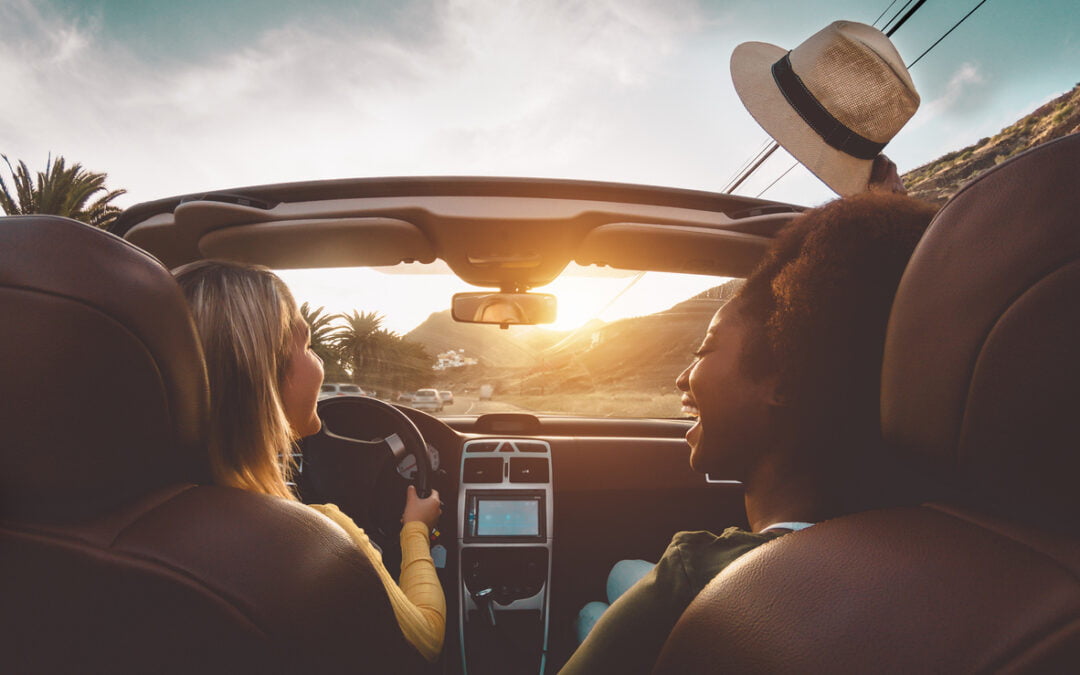 Happy girls doing road trip in tropical city - Travel people having fun driving in trendy convertible car discovering new places - Friendship and youth girlfriends vacation lifestyle concept - rental car insurance