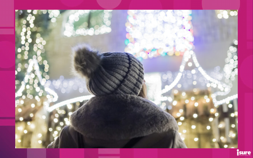 christmas light safety tips - woman gazing at the beautiful christmas lights on her home at night