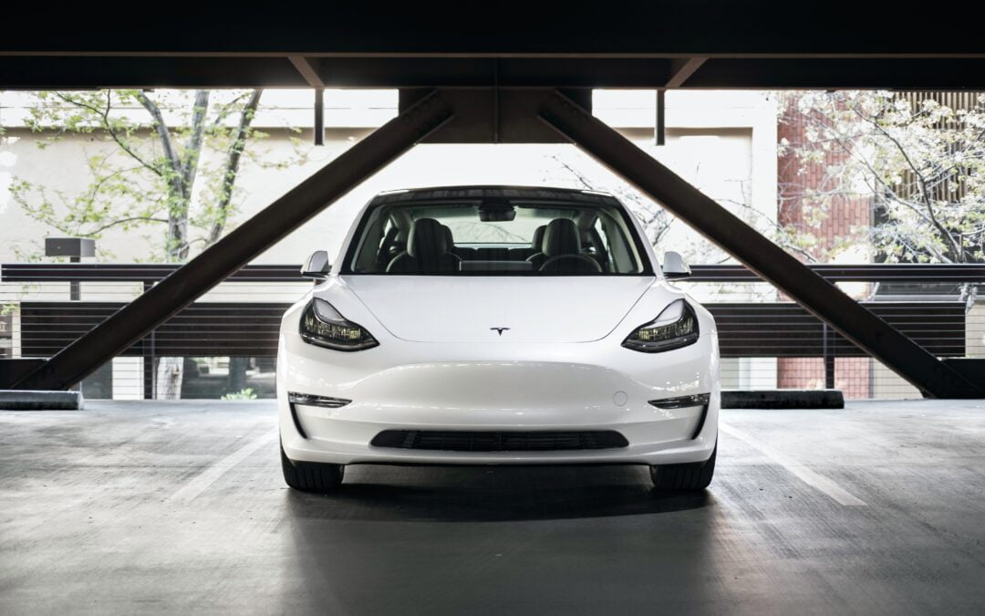 White Tesla car inside a parking garage - best 2022 electric vehicle brands