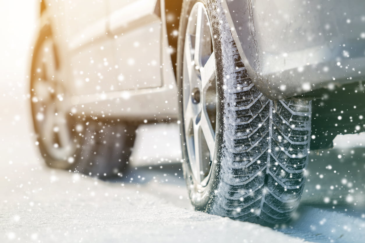Close-up of car wheels rubber tires in deep winter snow. Transportation and safety concept. winter tire maintenance