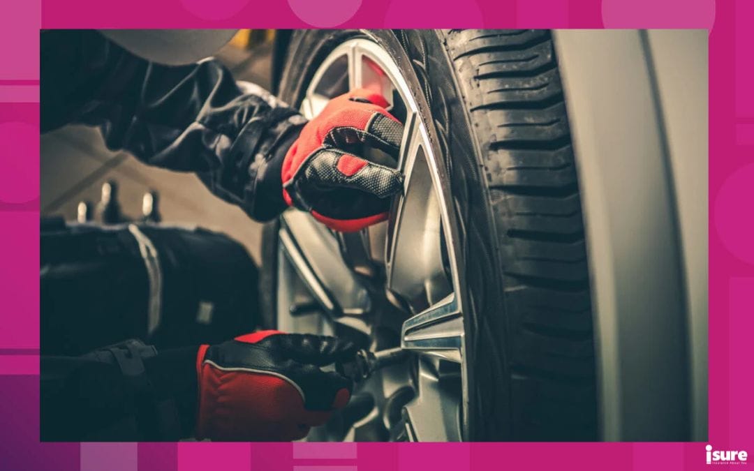 Seasonal Tires Replacement Automotive Photo Theme. Tire Sales Worker Finishing Change of Car Wheels. Closeup Photo. Replace your car tires