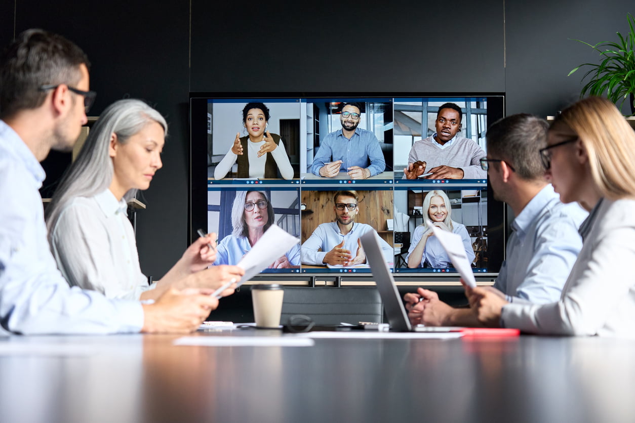 Global corporation online video conference in meeting room with diverse people sitting in modern office and multicultural multiethnic colleagues on big screen monitor. Business technologies concept - risk management in office