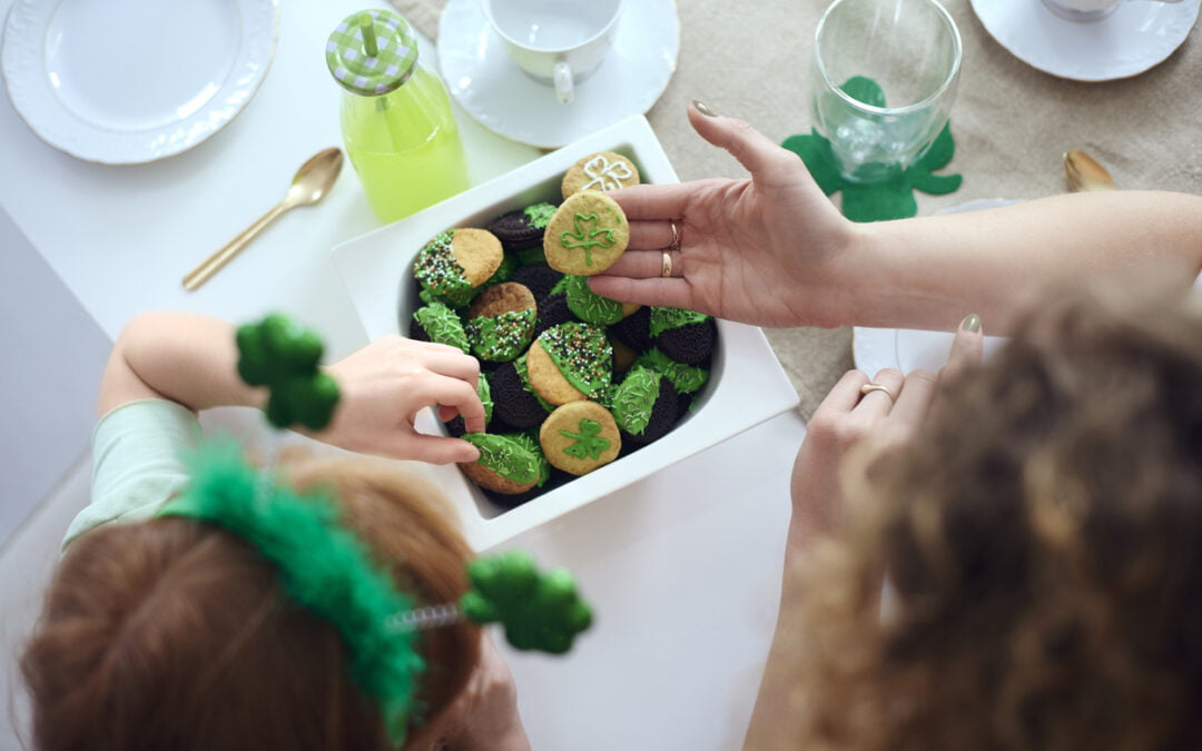 Woman and child tasting Saint Patrick's Day cookies at kitchen