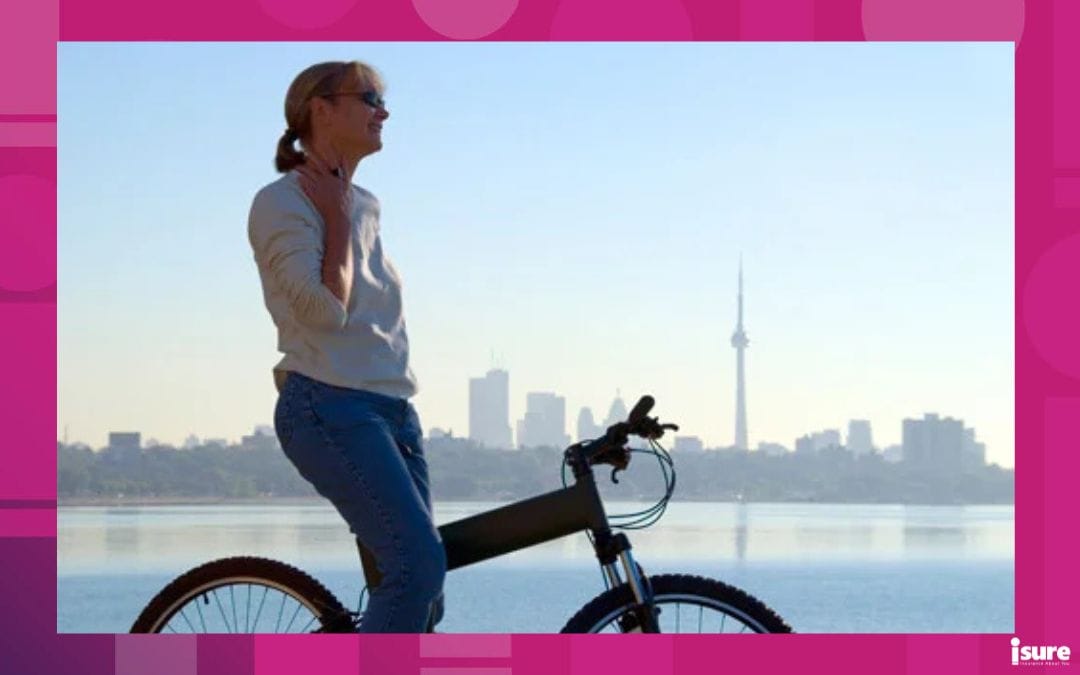 woman riding an e-bike with the toronto skyline in the background