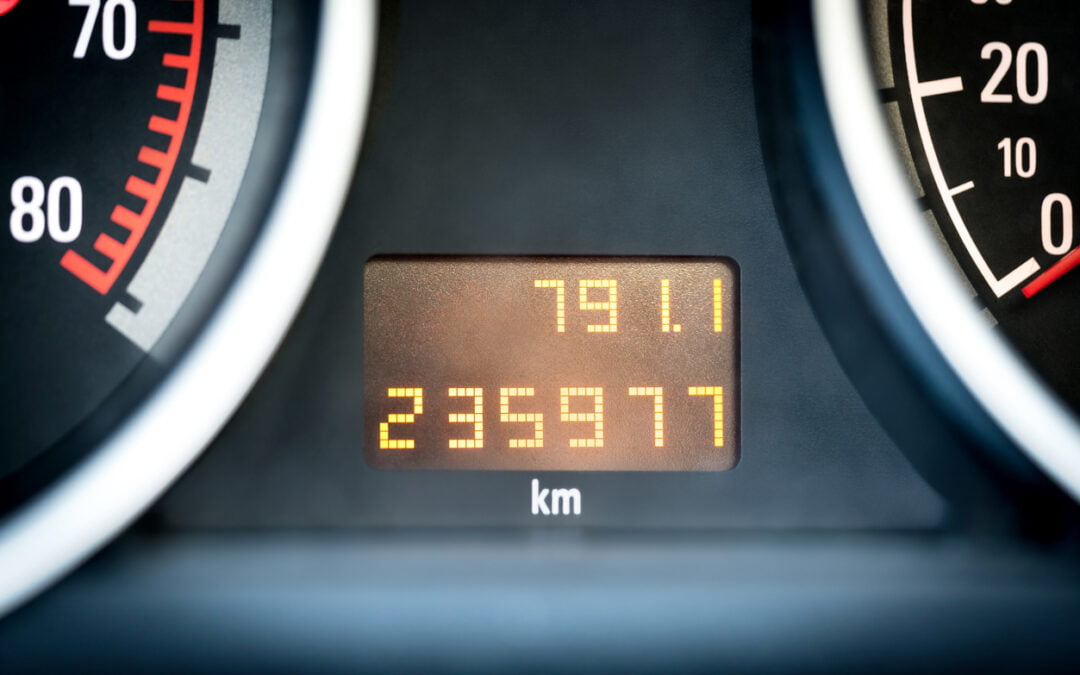 Digital car odometer in dashboard. Used vehicle with mileage meter. Numbers in kilometers. Average mileage driven