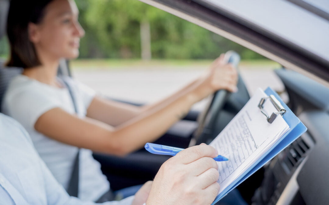 drive tests in Ontario - Instructor of driving school giving exam while sitting in car