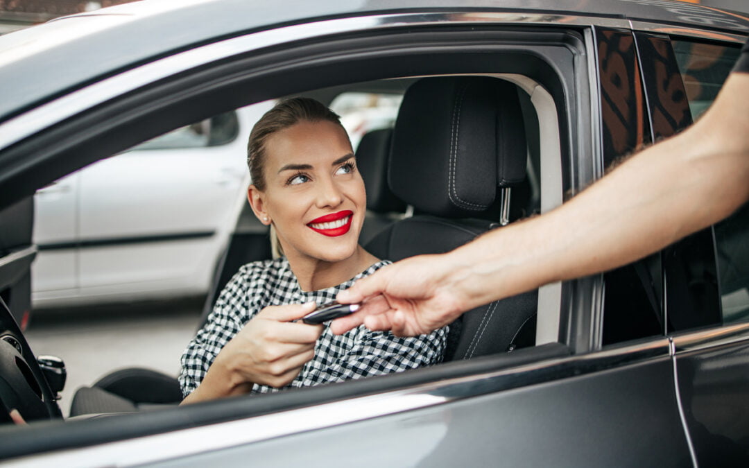 Satisfied and smiled female buyer sitting in her new car. She is smiling, looking at seller through open window while taking car keys from him - Ontario Policy Change Forms