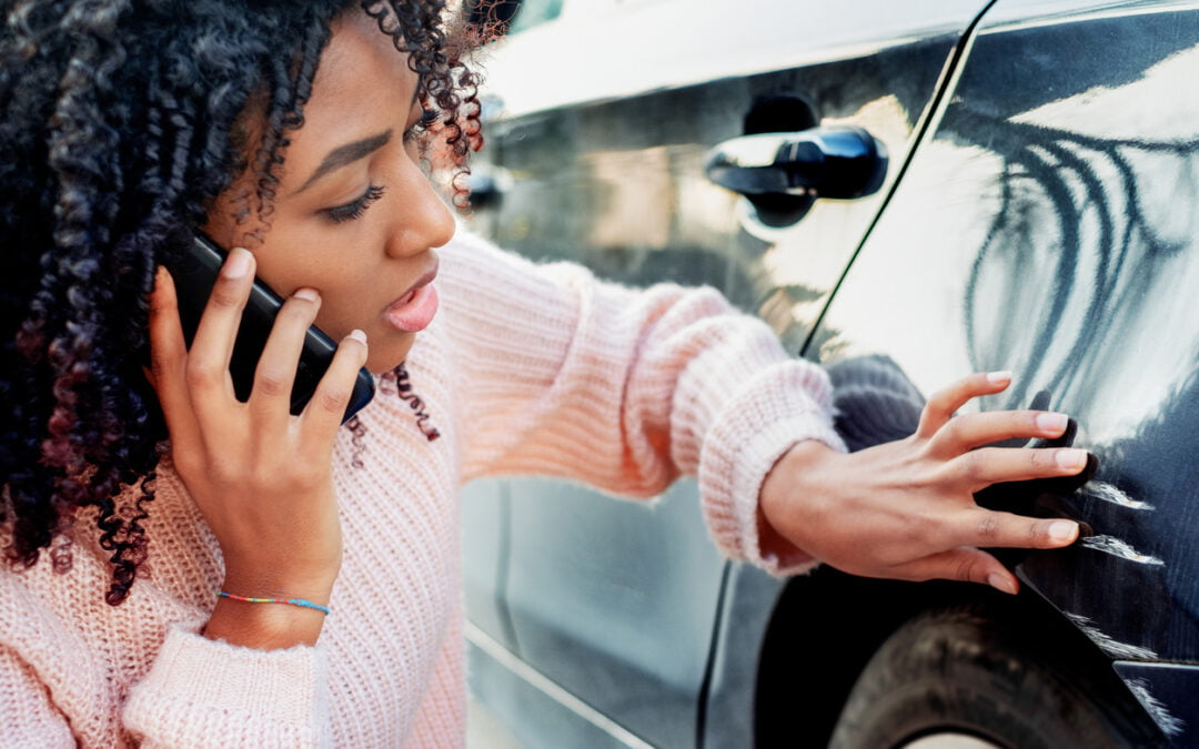 comprehensive auto insurance - Black woman feeling sad after scratching car bodywork