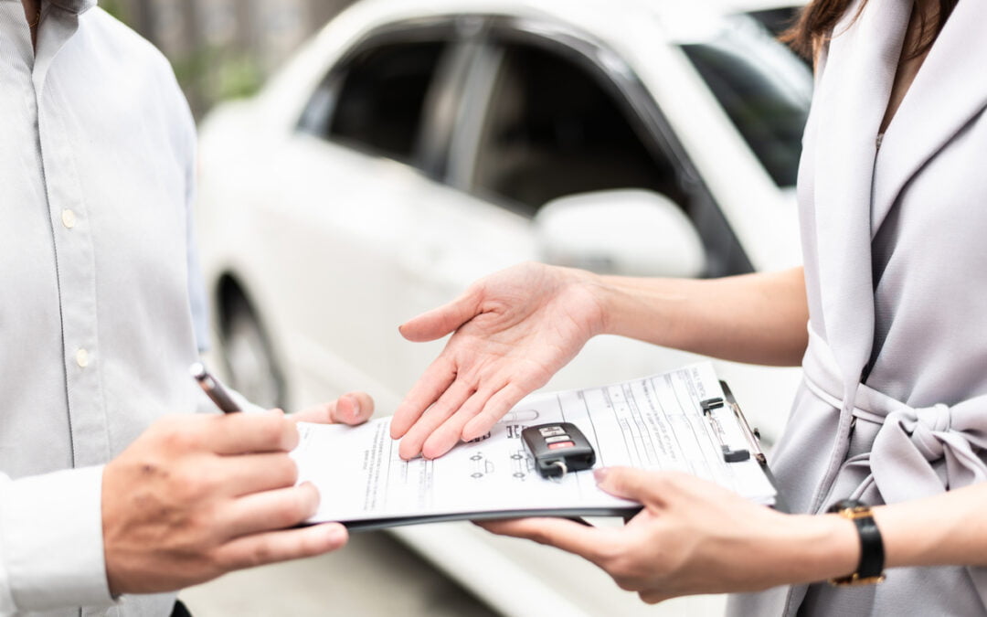 lease takeover - Automotive business, car sale or rental concept : Happy customer with car dealer agent making deal and signing on agreement document contract in auto showroom or car dealer office.