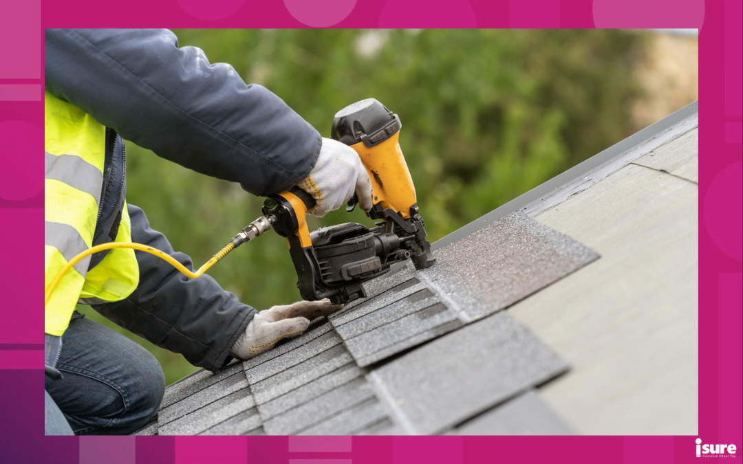 maintain your roof - Unrecognizable roofer worker in uniform work wear using air or pneumatic nail gun and installing asphalt or bitumen tile on top of the roof under construction house