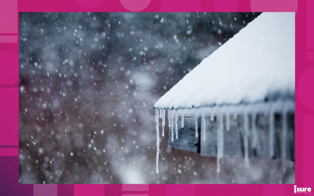 winter home maintenance tips - icicles hanging from a home's roof while snowing
