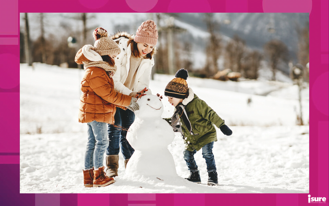 family winter activities - happy family mother and children daughter and son having fun building a snowman