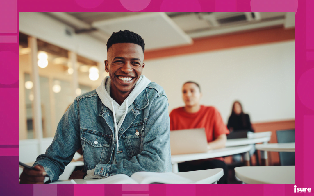 become an insurance broker in ontario -African student sitting in classroom. Male student smiling during the lecture in high school classroom.