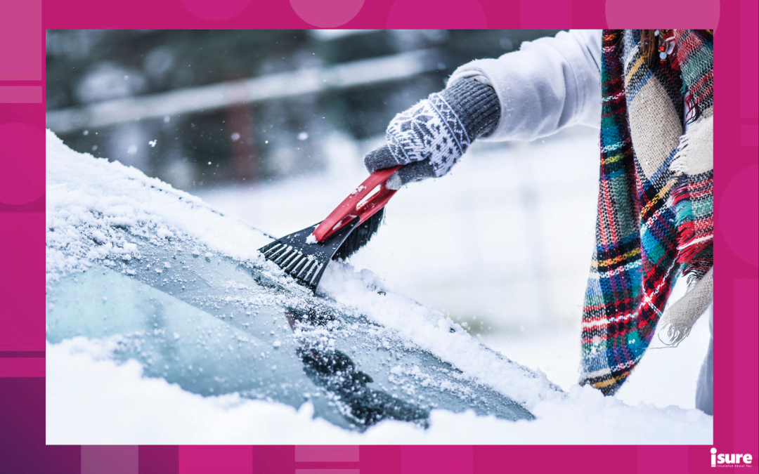 Woman cleaning snow from windshield,