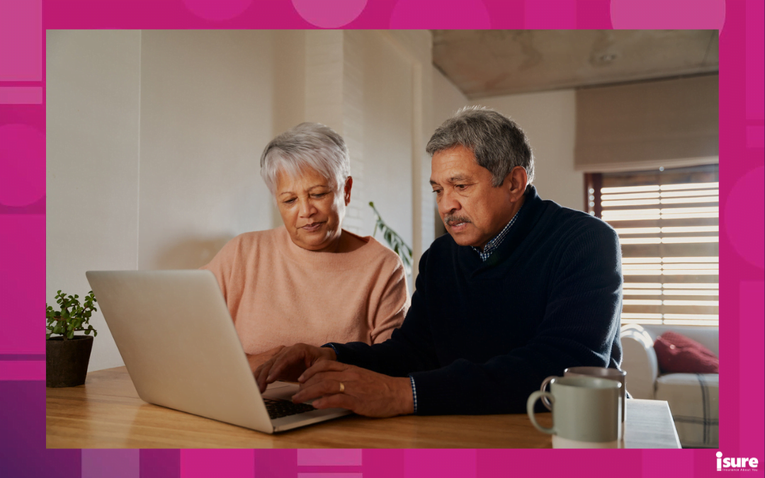 Ontario tax credits for seniors - Elderly multi-ethnic couple researching holiday destinations on their laptop sitting at home. Retired and happy.
