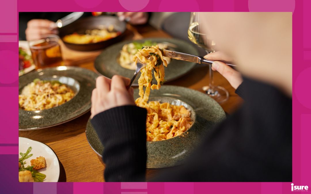 best restaurants in Toronto - man eating pasta close-up in a stylish cafe and company of friends