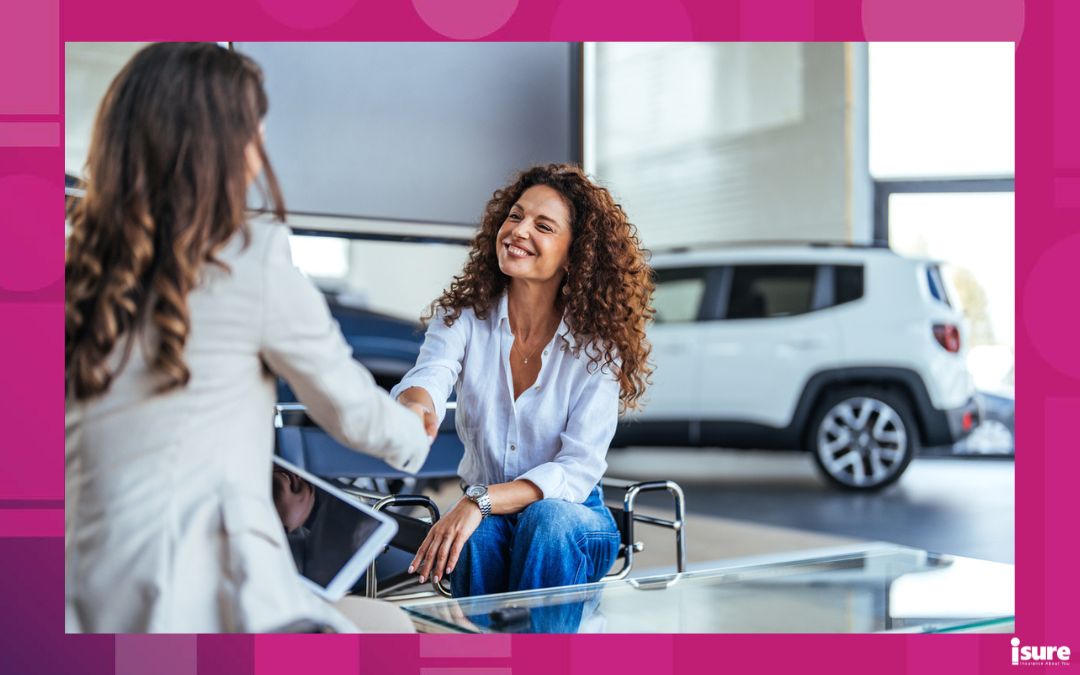 financing your car bank vs dealership - Smiling car saleswoman discussing a contract with a female customer. Saleswoman showing contract to customer. Happy saleswoman with folder giving car key to new owner.