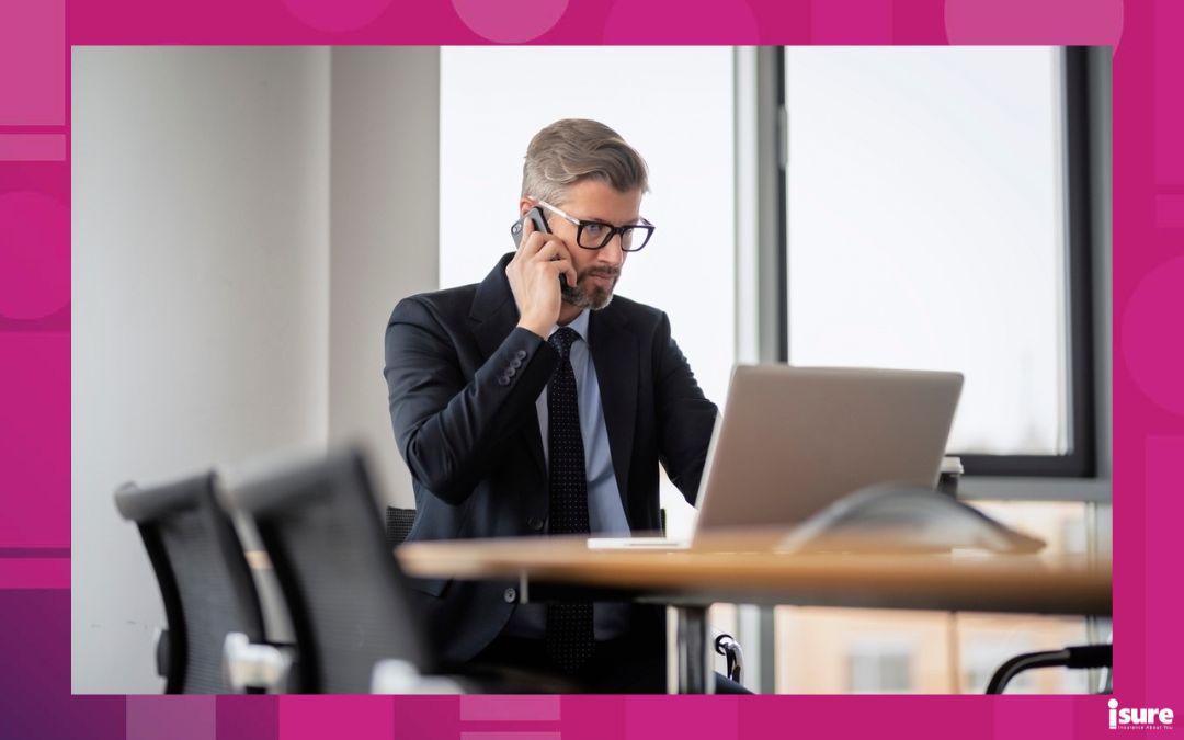 Concerned businessman in suit looking at laptop in board room.