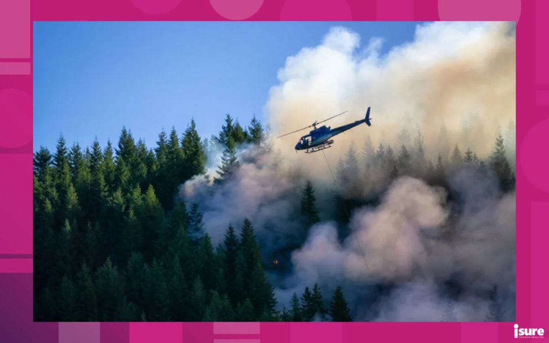 climate change and home insurance - helicopter spraying water onto burning forest