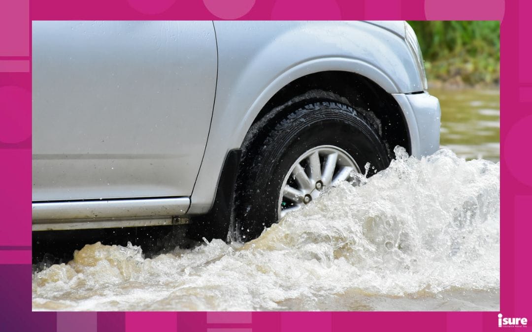 water main flooding - Closeup view of the rear wheel of a black pickup truck that was passing through a flood, car insurance and car fixing concept.