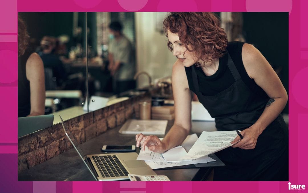 A young business owner using her laptop and phone.
