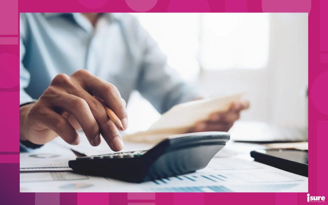 up close visual of someone typing auto insurance premium calculations into a calculator