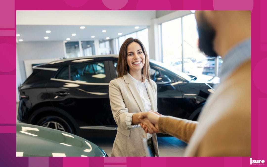 negotiate car price - Portrait of smiling female customer standing at car salon and shaking hands with salesman.