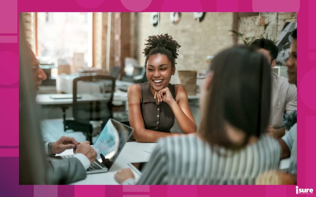 We are one team! Young and cheerful afro american woman smiling while having a meeting with colleagues in the modern office. Business concept - tenants legal liability insurance