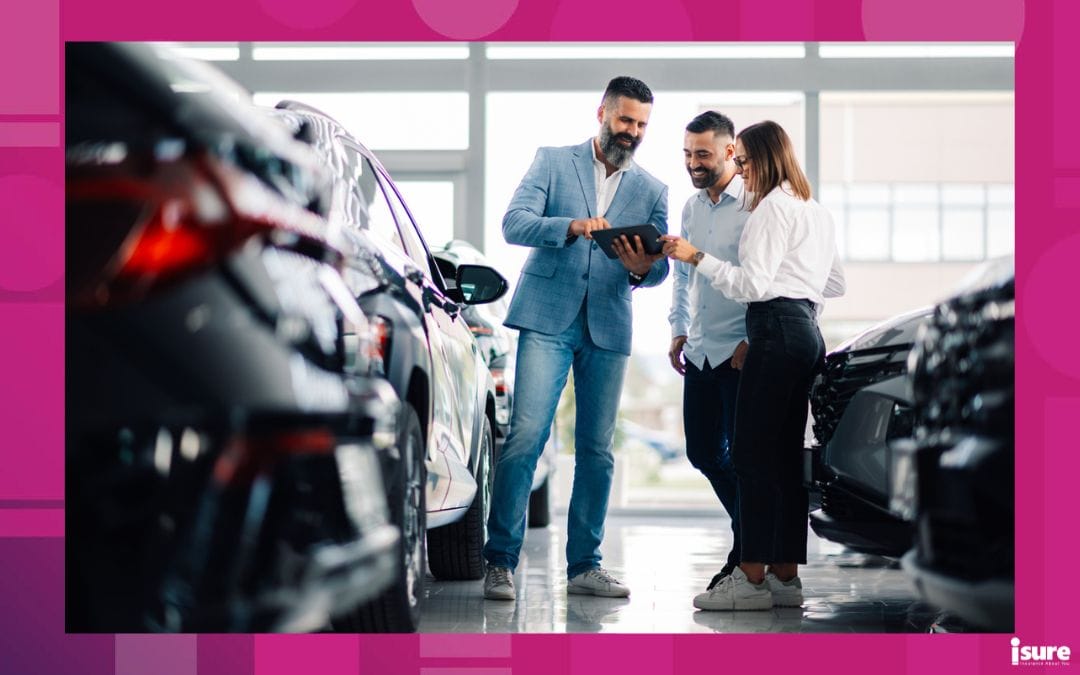 A car dealership scene with three people discussing vehicle choices and vehicle value while looking at a tablet, surrounded by various cars in a bright showroom setting.