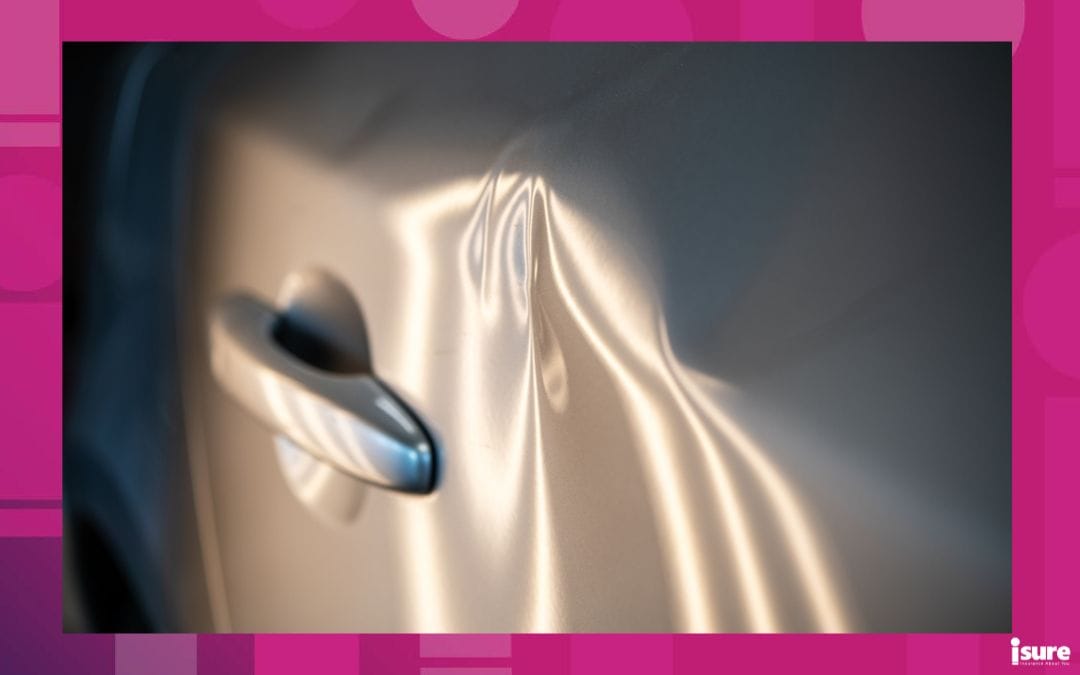 The side of a car, dented from an accident.