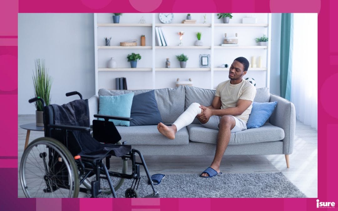 Young black man with injured leg sitting on sofa, trying to get to wheelchair at home, full length. Millennial man suffering from pain in plastered limb, having trouble moving around house, copy space, experiencing accident benefits changes in Ontario