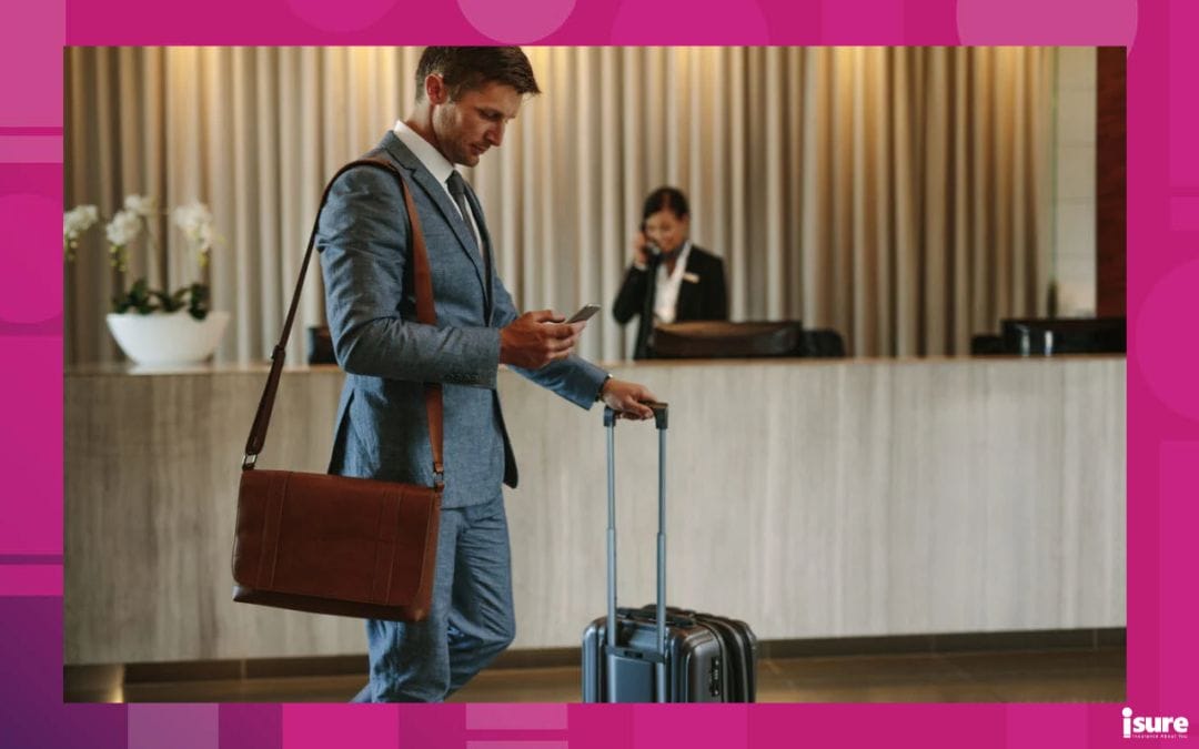 Young businessman walking in hotel lobby and using mobile phone. Business traveler arriving at his hotel. Umbrella insurance policy