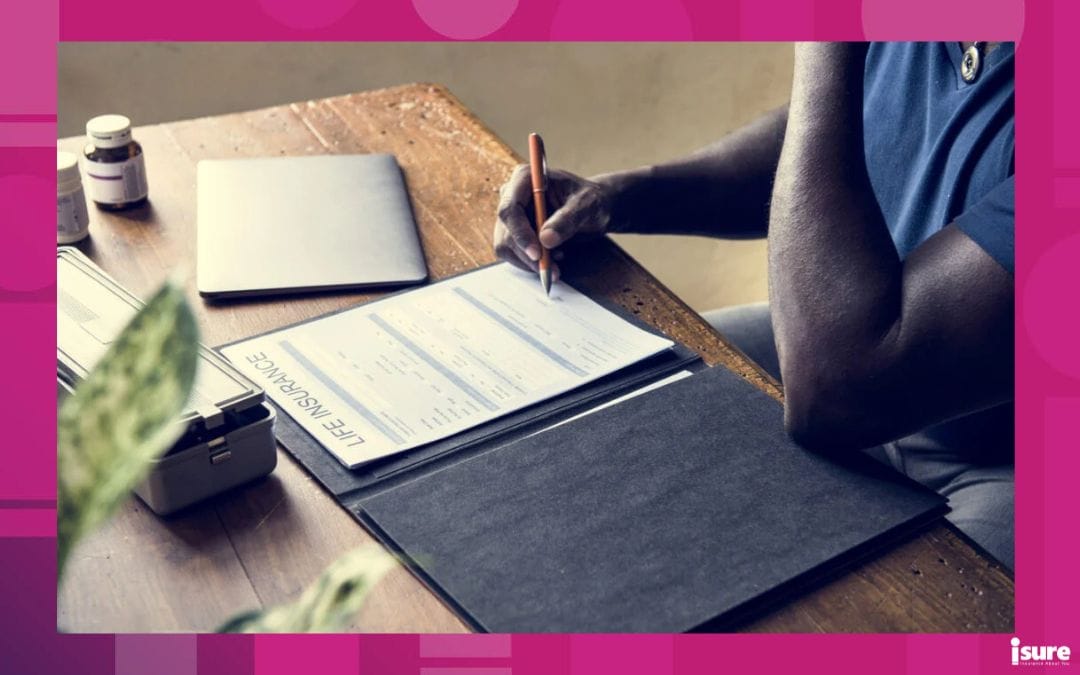Closeup of hand signing life insurance paper form.