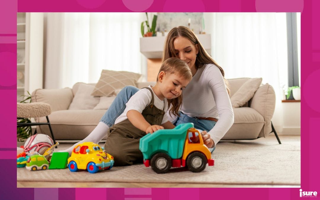 life insurance policy types - young mother plays with her little son with toys at home and smiles, 2-year-old boy plays with toy car with his parent, woman has fun with her child