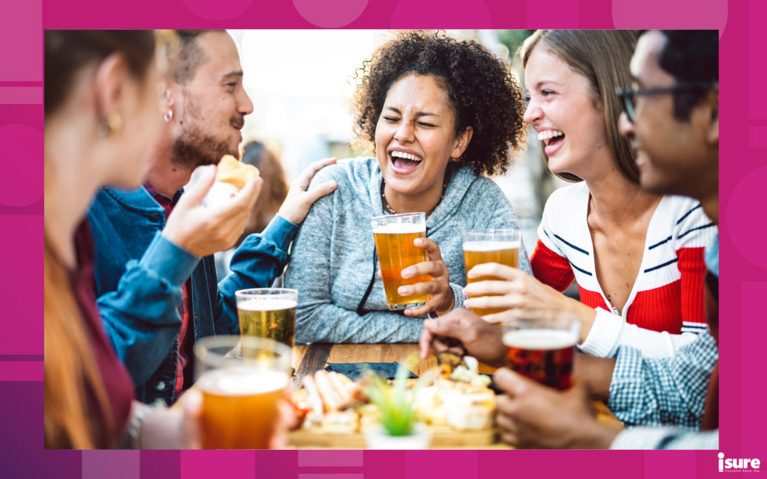 A group of people smiling and laughing together at a patio in Ottawa.