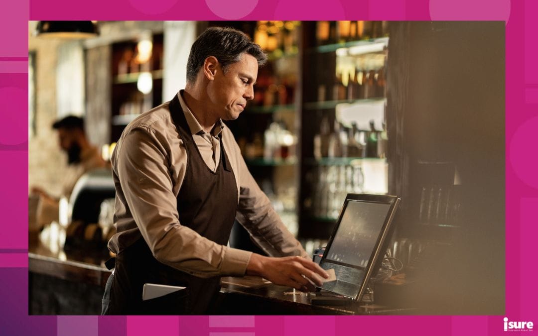 Mid adult barista checking orders at cash register while working in a pub, possibility of pos system breach without proper coverage