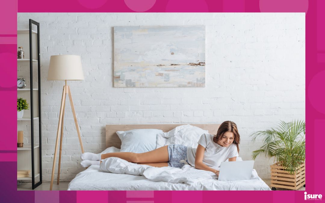 happy woman using laptop while relaxing in bedroom - room sharing