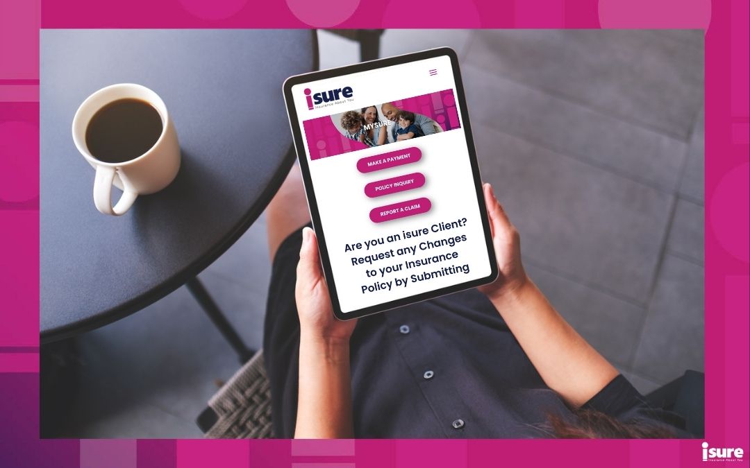 overhead view of a person holding their tablet on the isure.ca's website page to submit a claim, explaining the home insurance claims process. There is a coffee in the background on a table