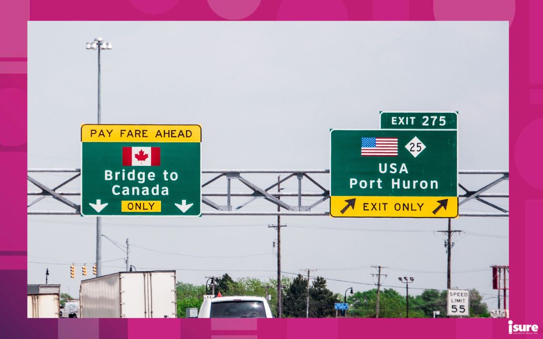 driving toward the u.s. border with canada and US signs on the highway