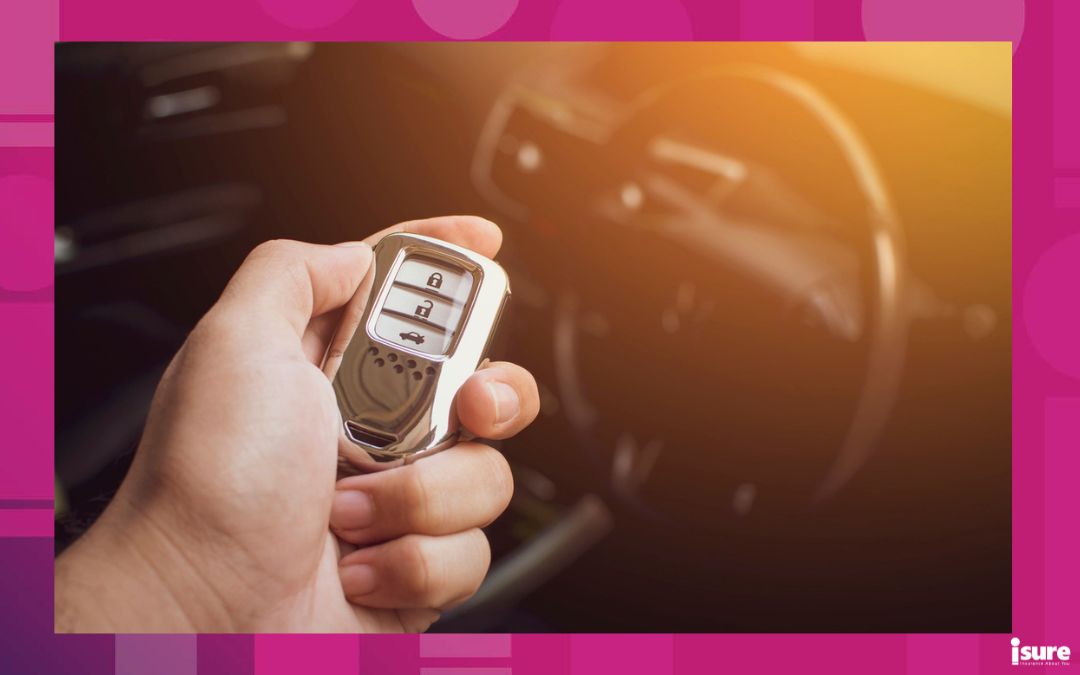 Driver's hand holding the car keyless remote - smart keys and auto theft