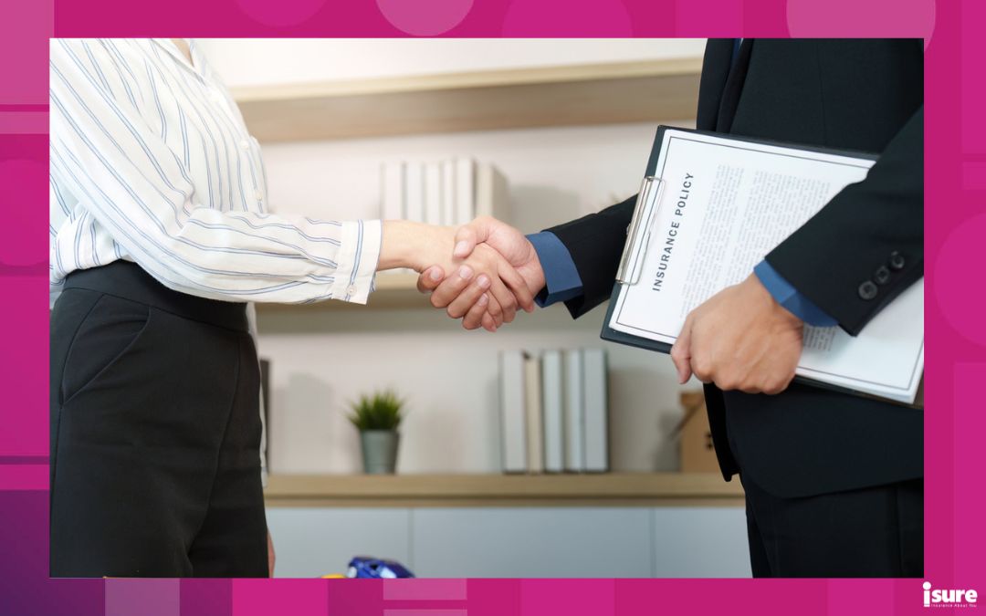 A client and insurance agent shake hands after finalizing an agreement, showcasing trust and professionalism while calculating auto insurance rates