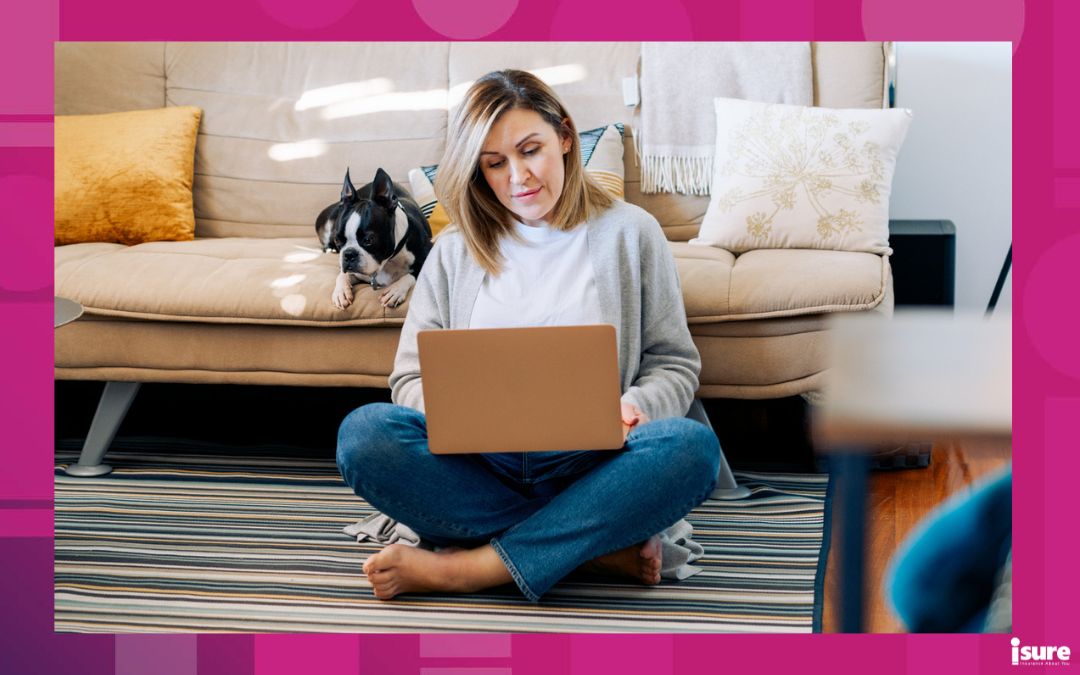 woman working from home looking at her personal insurance policies online with a boston terrier dog.