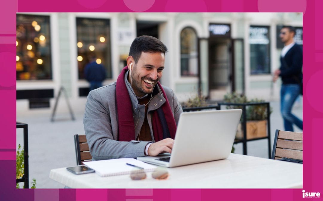 Handsome freelancer typing on his laptop at coffee shop, showcasing the importance of business winter safety tips