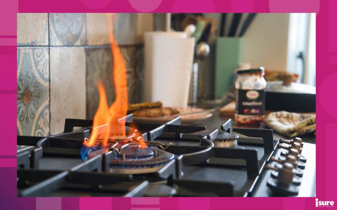 A gas stove burns with a bright flame during meal preparation. Various kitchen utensils and condiments are seen in the background, creating a vibrant atmosphere, with possibility of a kitchen fire
