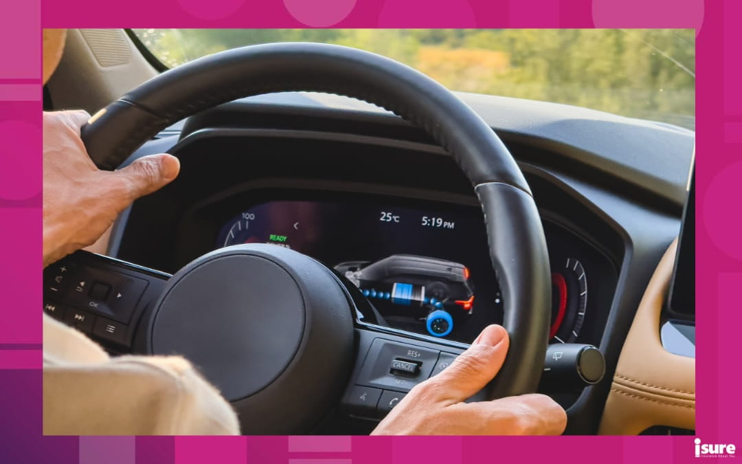 A person sitting behind the wheel of a hybrid vehicle.